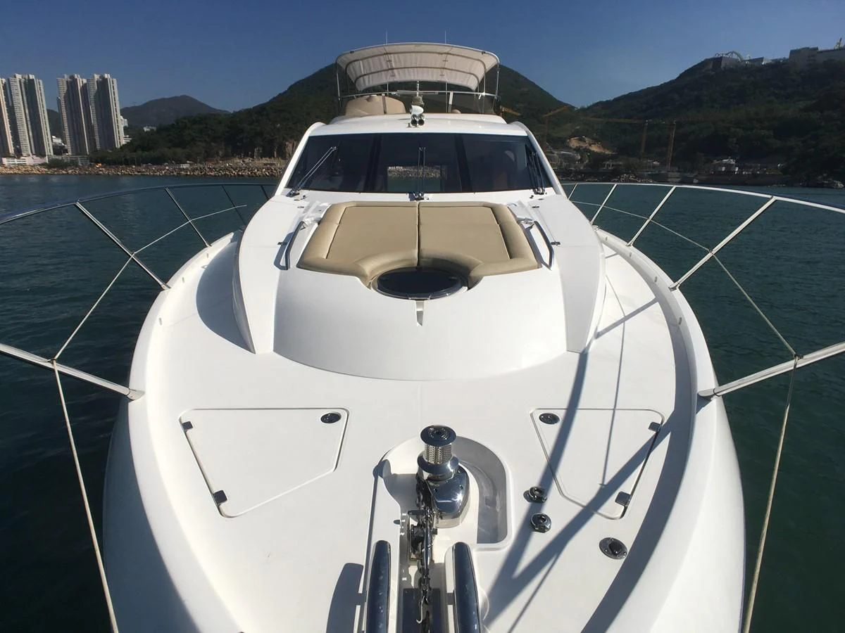 a white boat on a river aboard SUNSEEKER MANHATTAN 63 Yacht for Sale