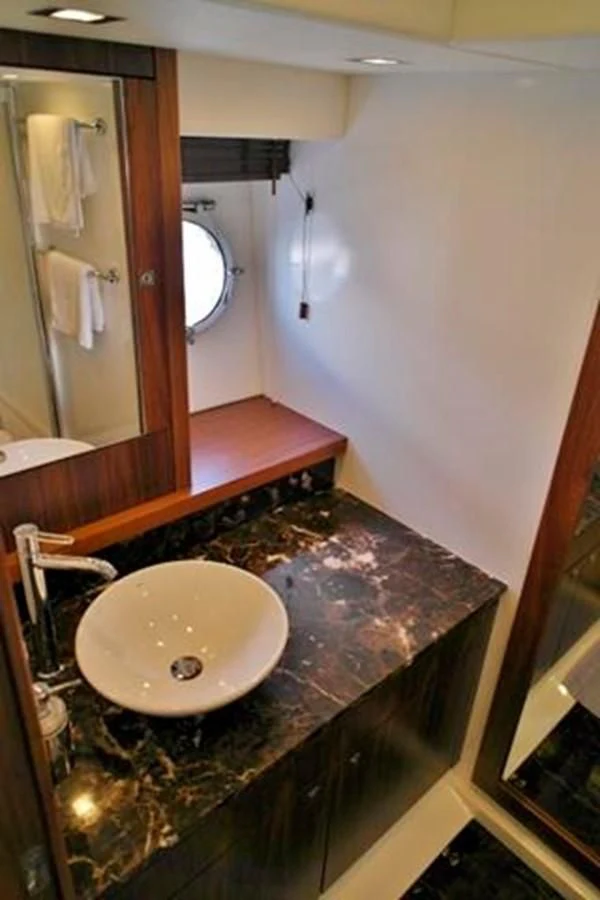 a bathroom with a sink and mirror aboard SUNSEEKER MANHATTAN 63 Yacht for Sale