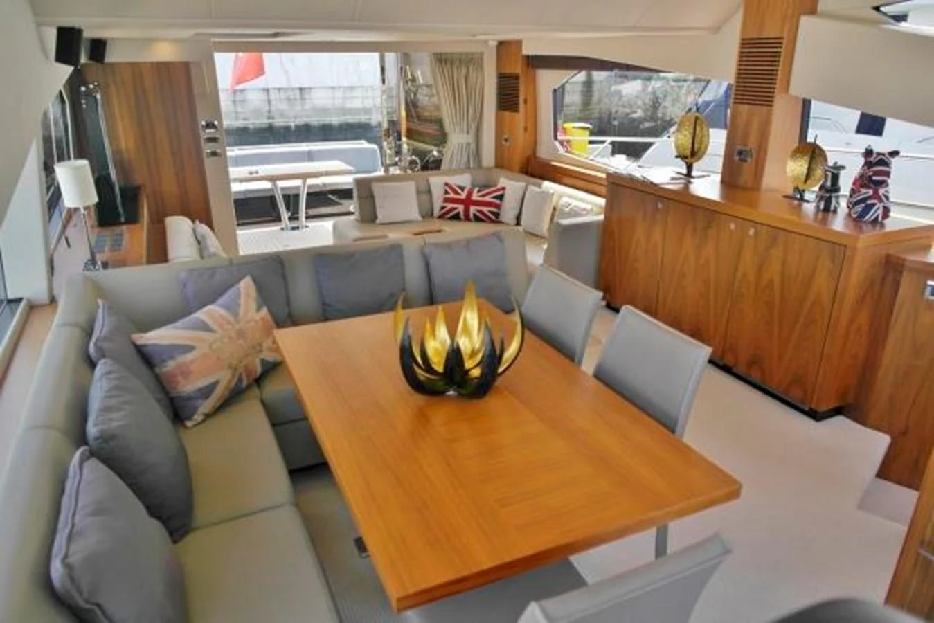 a living room with a table and couches aboard SUNSEEKER MANHATTAN 63 Yacht for Sale