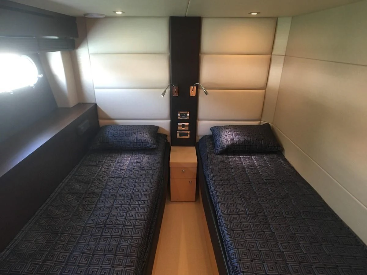 a room with a black bed and a black and white rug aboard SUNSEEKER MANHATTAN 63 Yacht for Sale