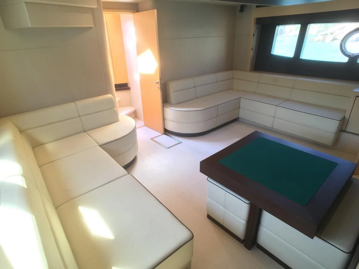 a room with a table and a tv aboard SUNSEEKER MANHATTAN 63 Yacht for Sale