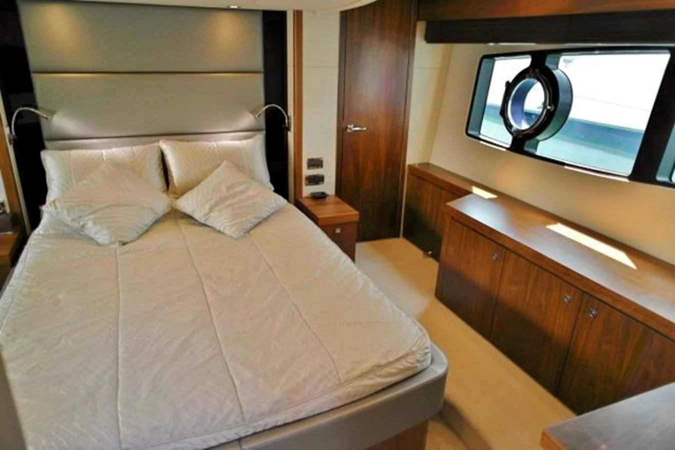 a bed with a white comforter aboard SUNSEEKER MANHATTAN 63 Yacht for Sale