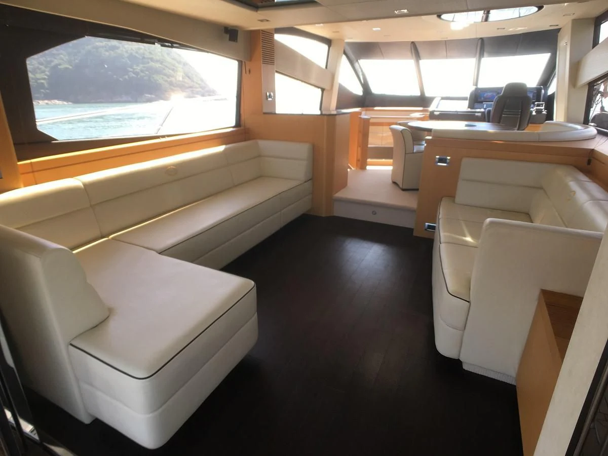 a room with a couch and a table aboard SUNSEEKER MANHATTAN 63 Yacht for Sale