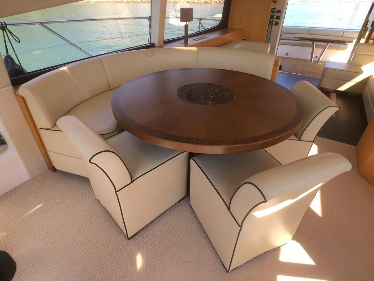 a room with a table and chairs aboard SUNSEEKER MANHATTAN 63 Yacht for Sale