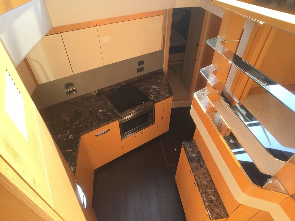 a kitchen with a stove and a wood counter top aboard SUNSEEKER MANHATTAN 63 Yacht for Sale