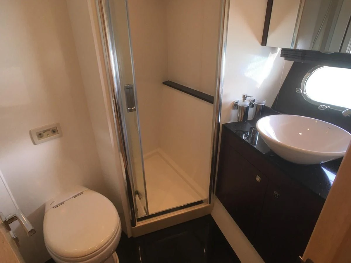 a bathroom with a glass shower door aboard SUNSEEKER MANHATTAN 63 Yacht for Sale