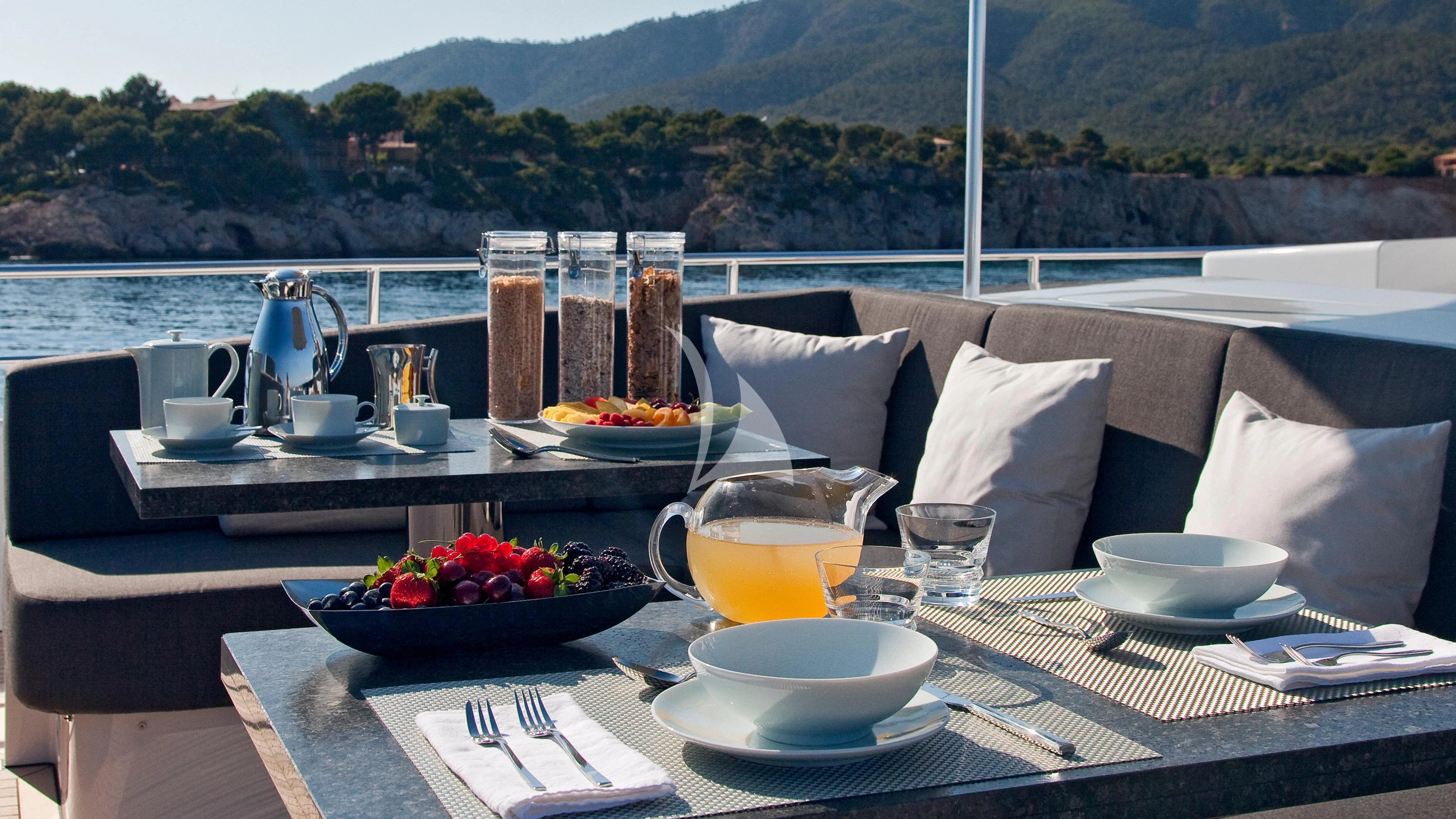 a table with food and drinks on it aboard JEMS Yacht for Sale
