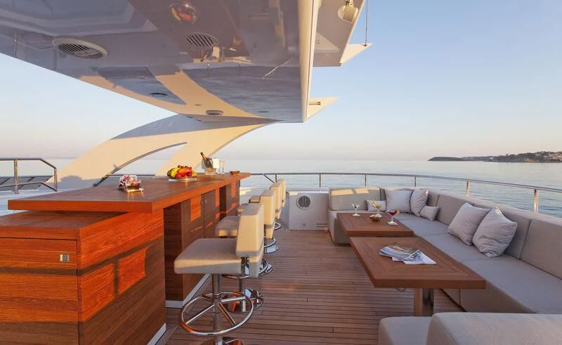 a room with a couch and a table and a large window aboard JEMS Yacht for Sale