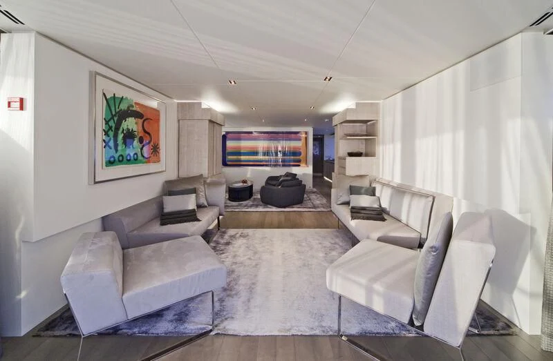 a living room with white couches aboard JEMS Yacht for Sale