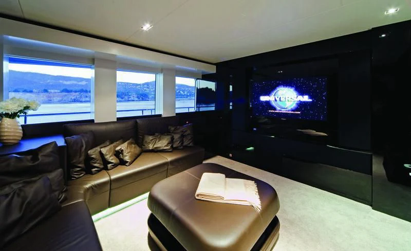 a living room with a large tv aboard JEMS Yacht for Sale