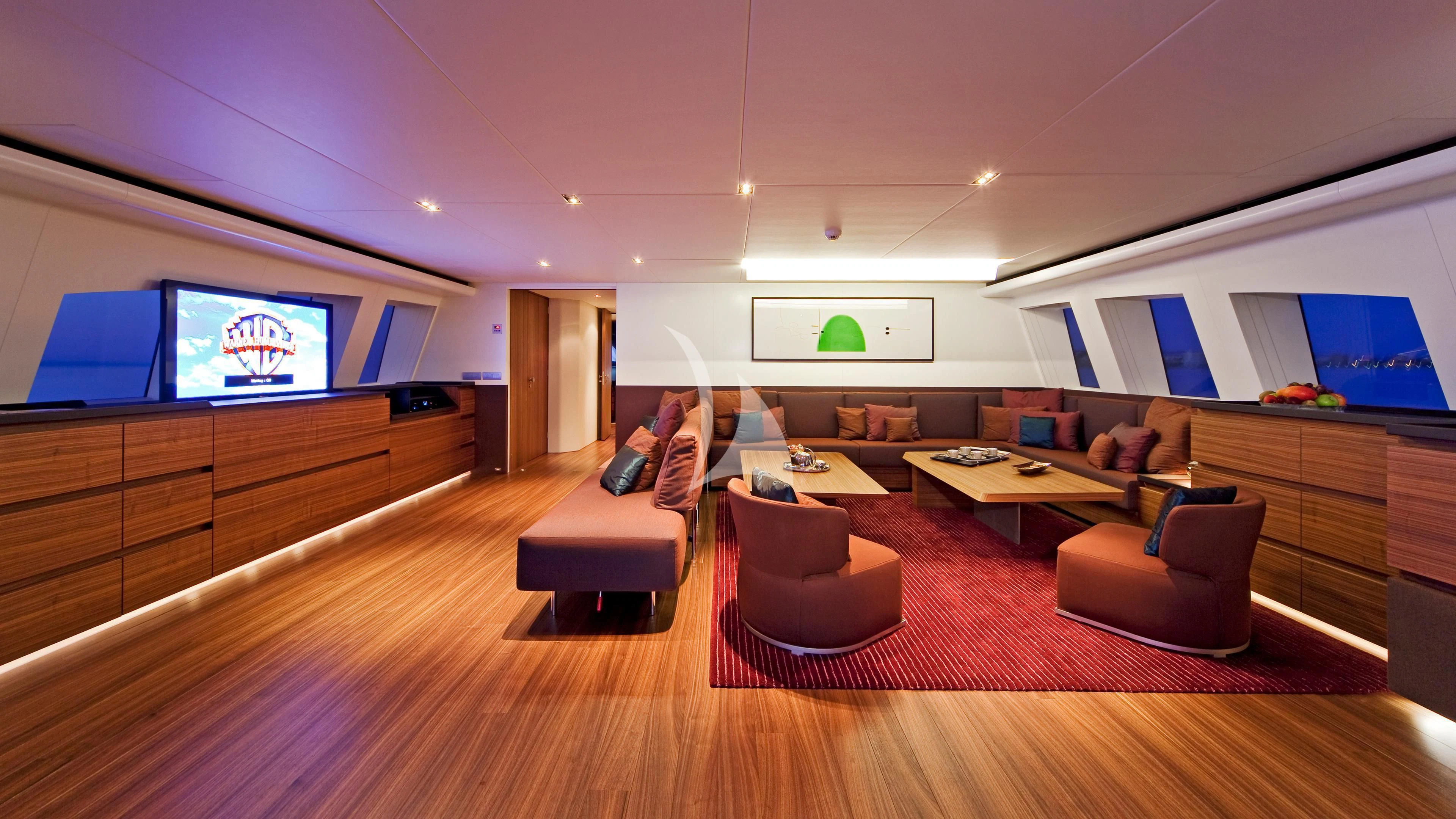 a large living room with a large screen aboard JEMS Yacht for Sale