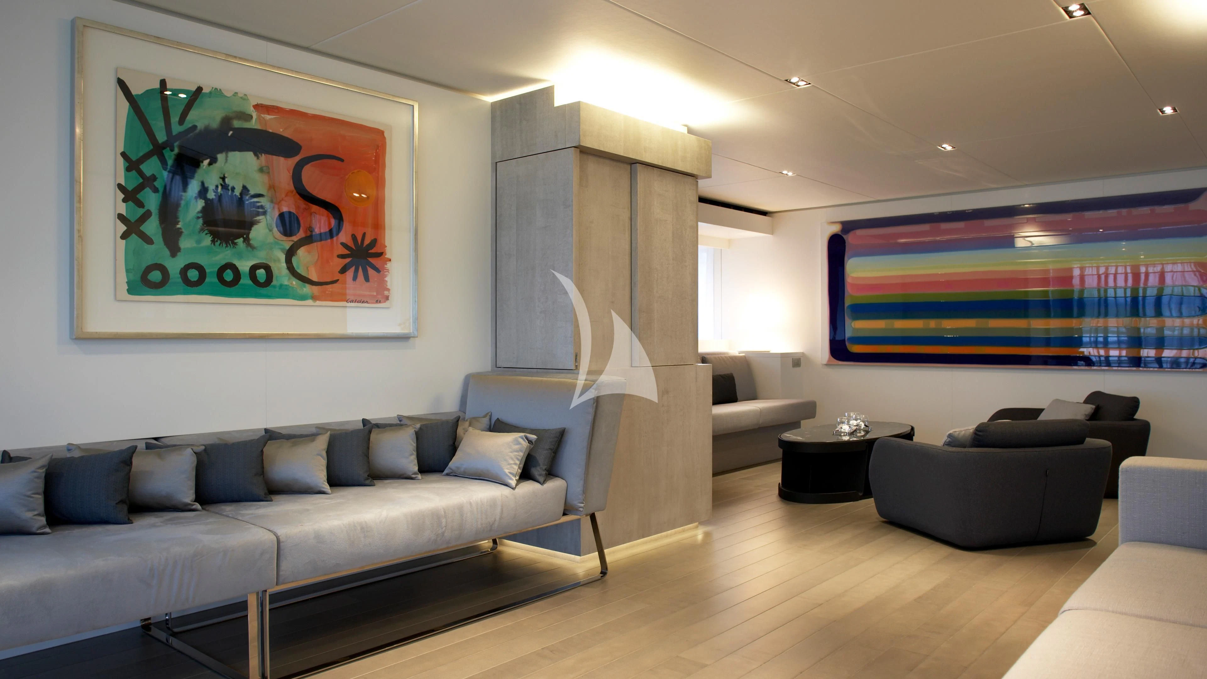 a living room with a large fireplace aboard JEMS Yacht for Sale