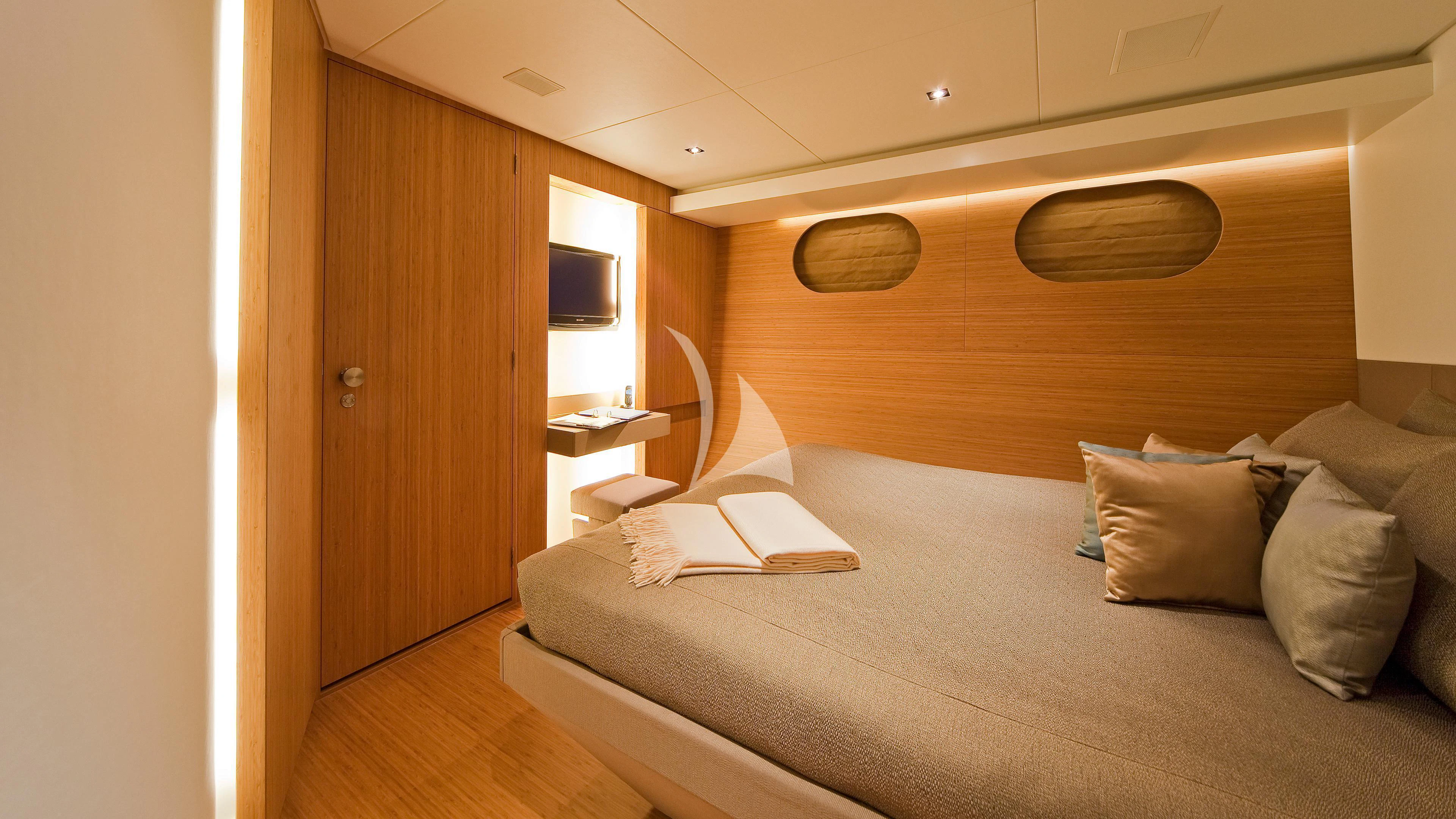 a bed with a white couch aboard JEMS Yacht for Sale
