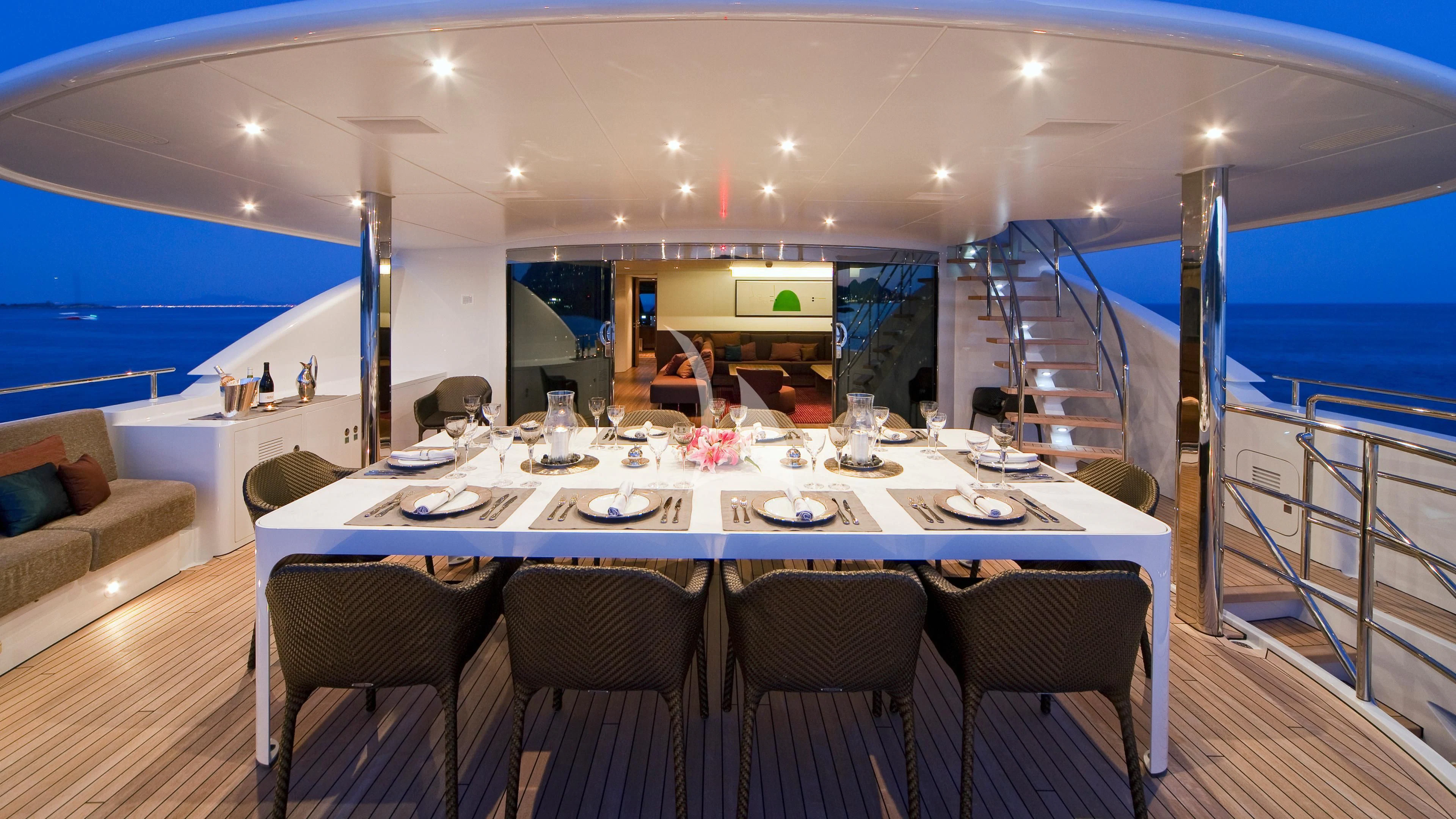 a large dining table in a room aboard JEMS Yacht for Sale