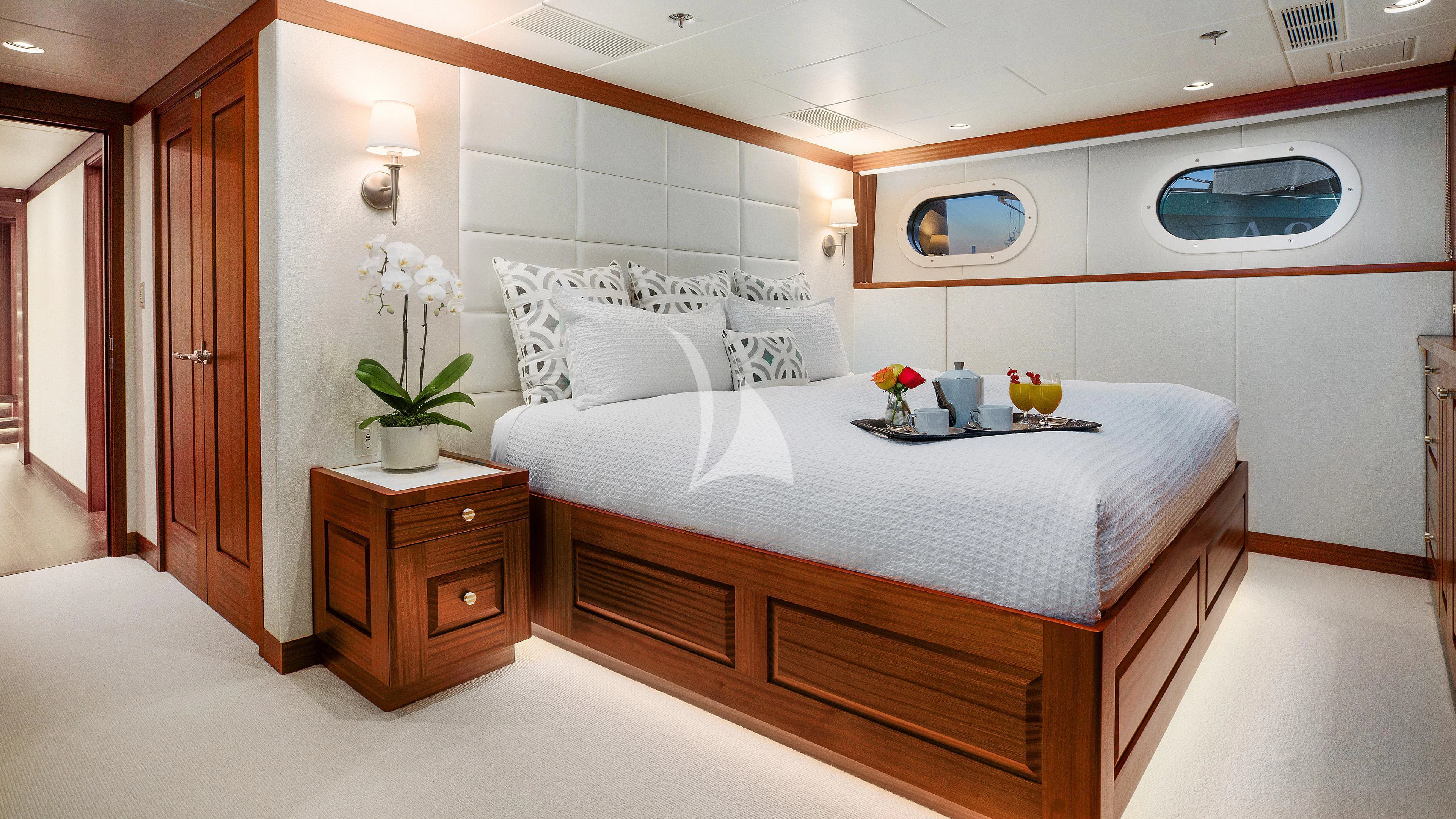 a bedroom with a bed and a desk aboard ENDLESS SUMMER Yacht for Sale