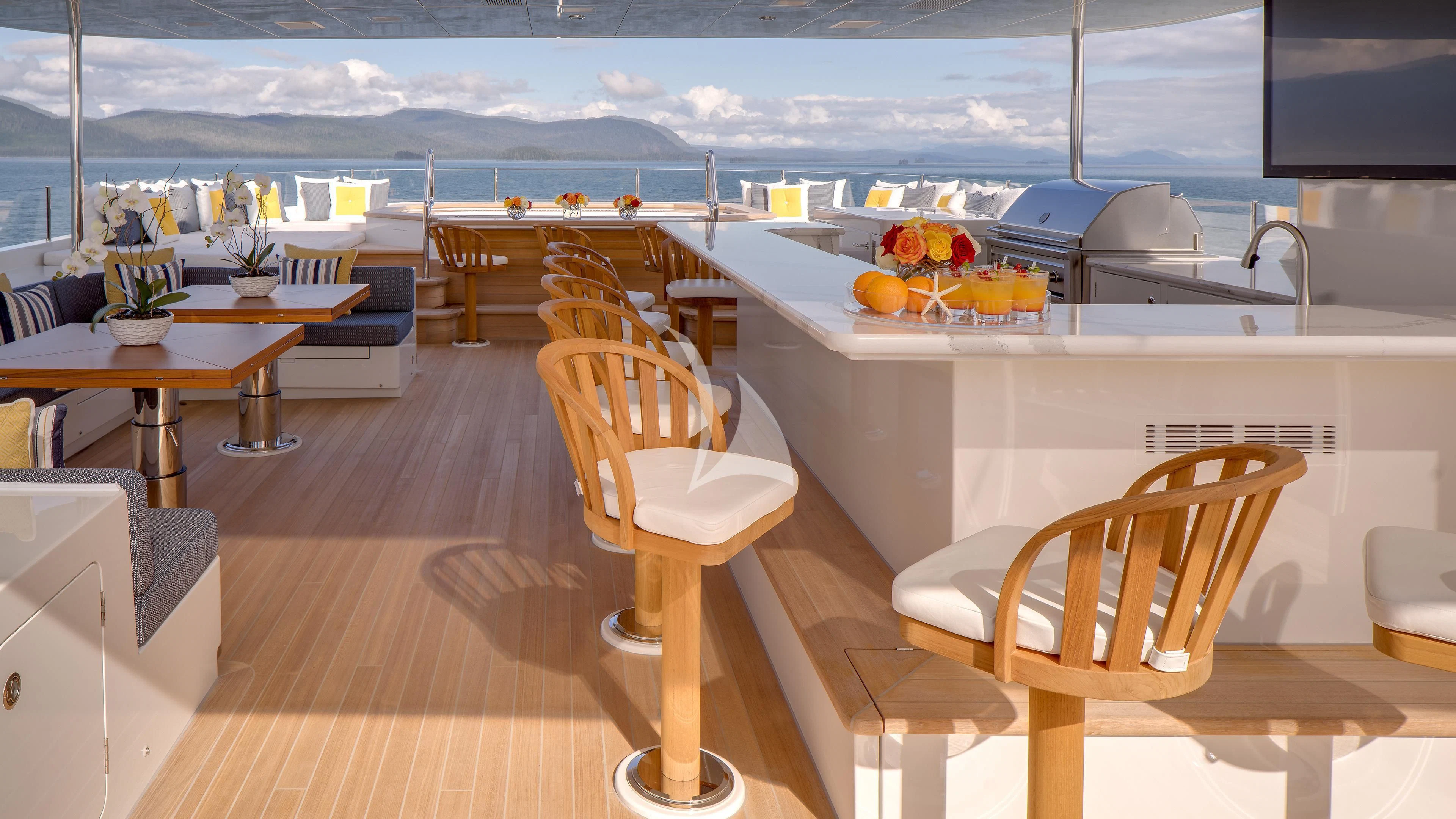 a room with a table chairs and a view of the ocean aboard ENDLESS SUMMER Yacht for Sale