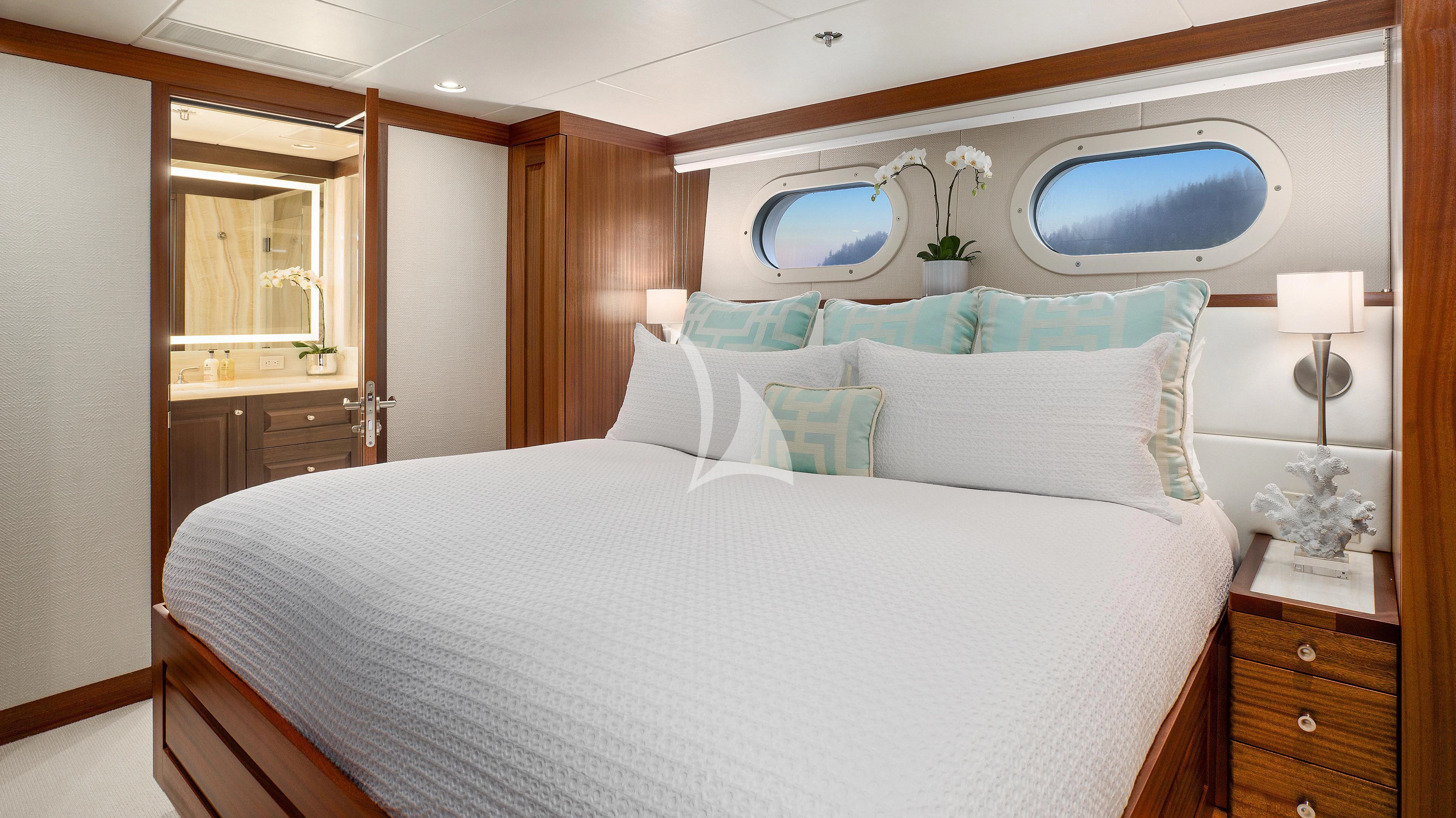 a bed with a white sheet and pillows aboard ENDLESS SUMMER Yacht for Sale