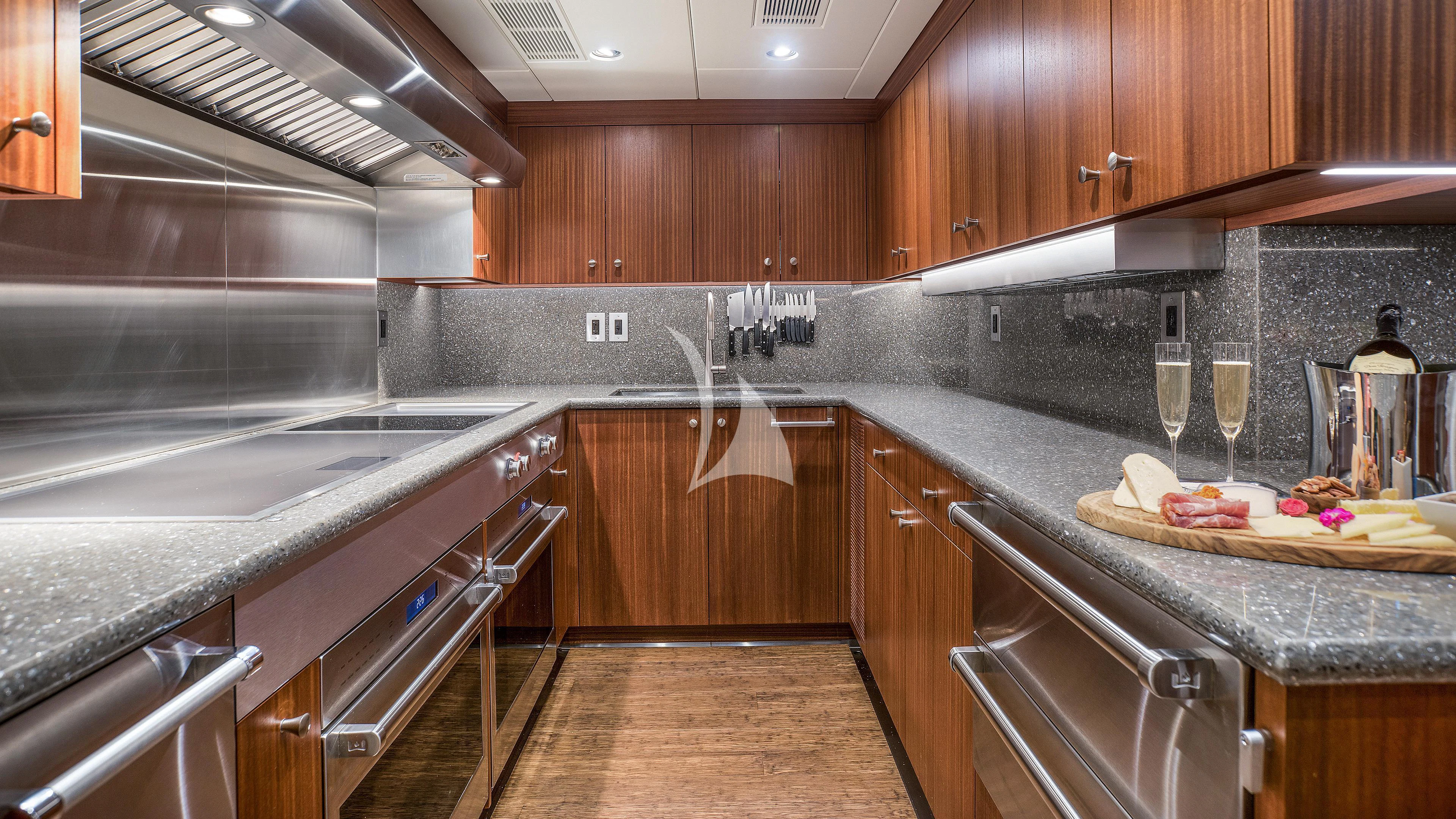a kitchen with wooden cabinets aboard ENDLESS SUMMER Yacht for Sale