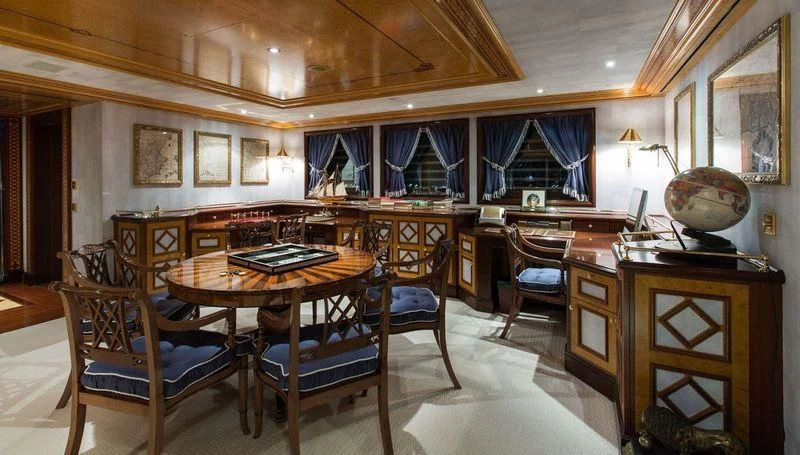 a large room with a table and chairs aboard GRAND OCEAN Yacht for Sale