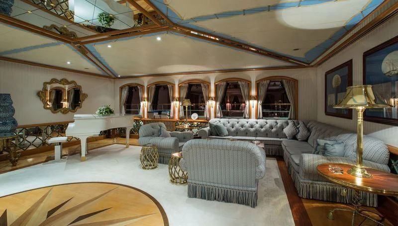 a large living room with a large chandelier aboard GRAND OCEAN Yacht for Sale