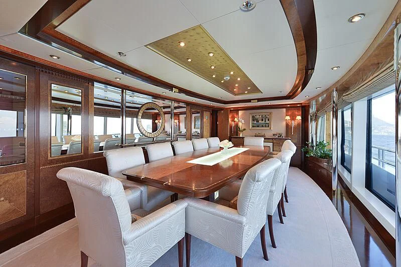 a large room with a table and chairs aboard LUDZIE Yacht for Sale