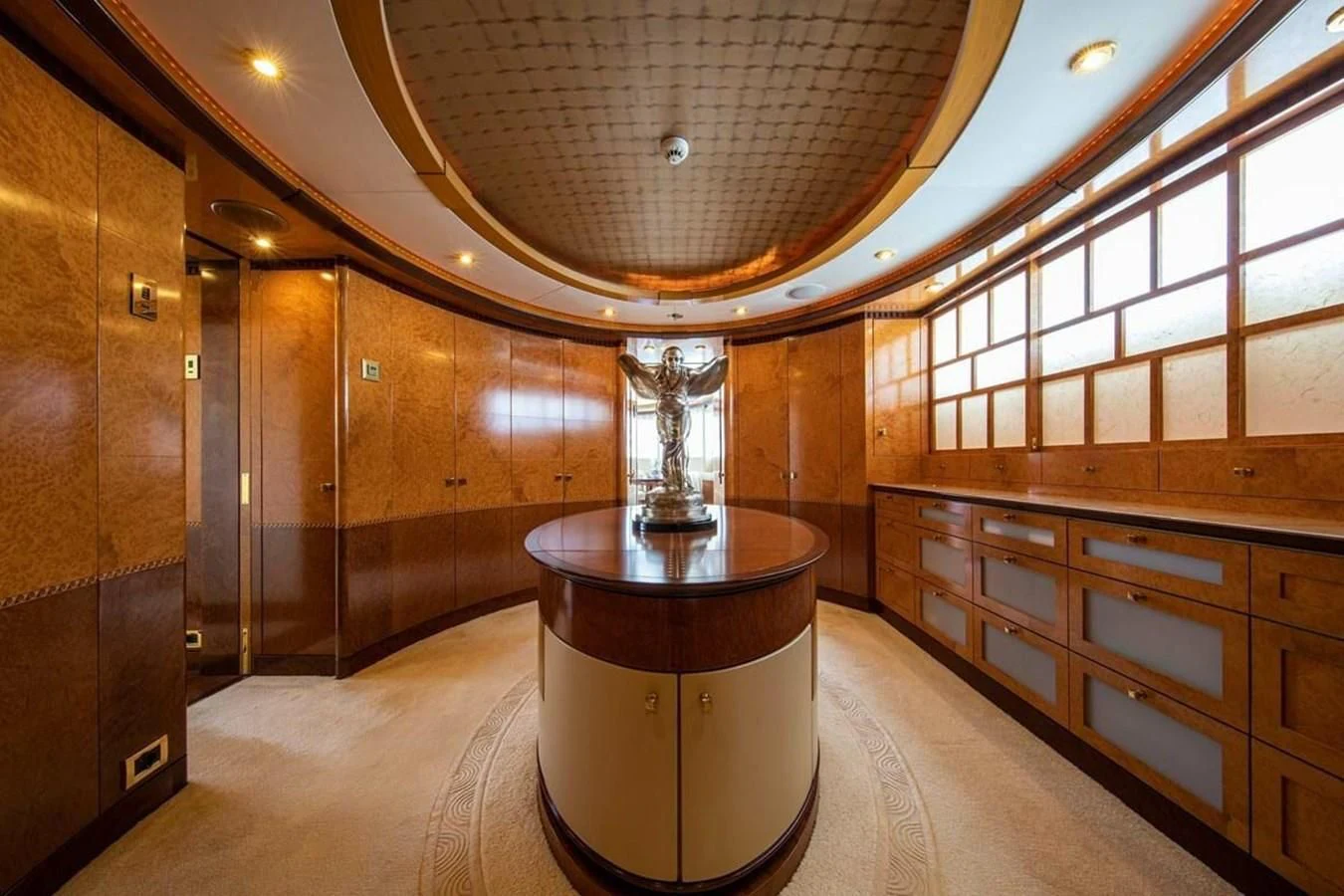 a large room with a large glass table and a large mirror aboard LUDZIE Yacht for Sale
