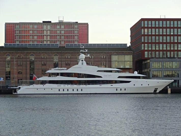 a large white boat in front of a building aboard LUDZIE Yacht for Sale