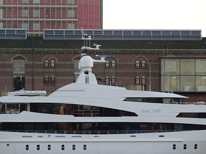 a white boat in front of a building aboard LUDZIE Yacht for Sale