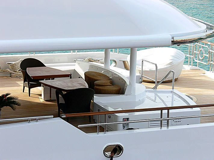 a white boat with chairs on it aboard LUDZIE Yacht for Sale