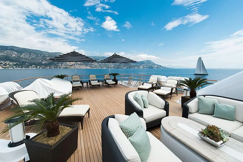 a patio with a table and chairs aboard LUDZIE Yacht for Sale