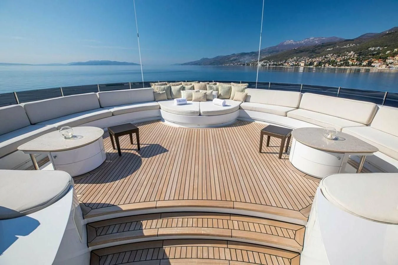 a deck with a view of the ocean and a city aboard LUDZIE Yacht for Sale
