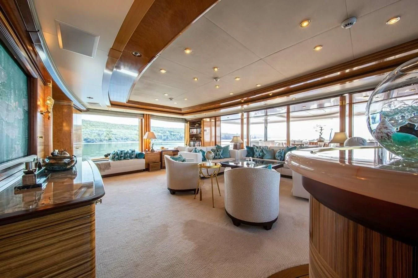 a room with a large window and a table with chairs aboard LUDZIE Yacht for Sale