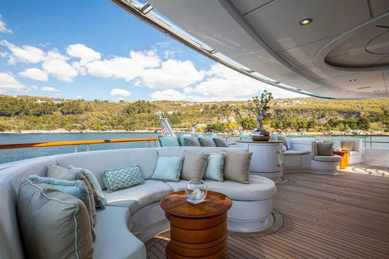 a living room with a large window overlooking a lake aboard LUDZIE Yacht for Sale