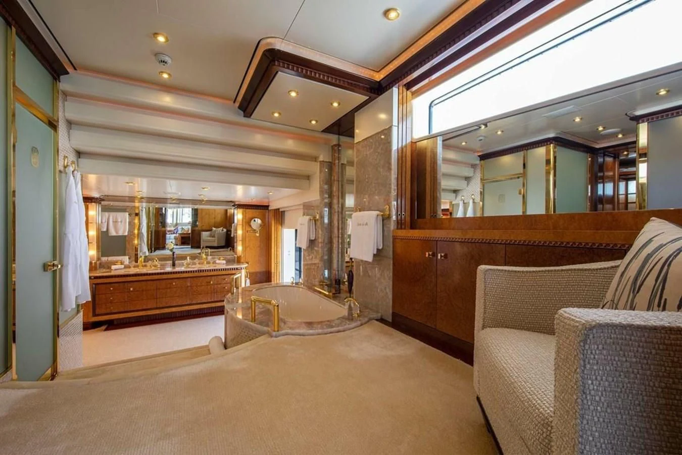 a room with a bed and a chair aboard LUDZIE Yacht for Sale