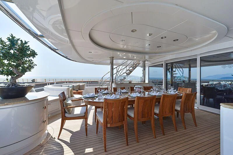 a large room with a table and chairs aboard LUDZIE Yacht for Sale