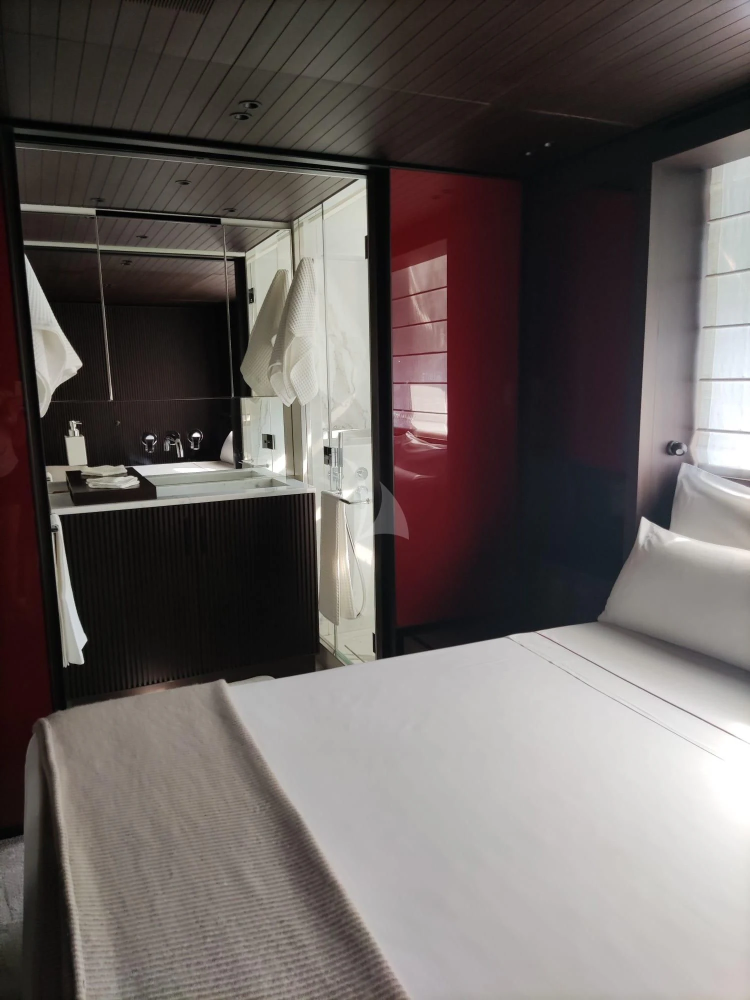 a room with a red door aboard LUAR Yacht for Charter