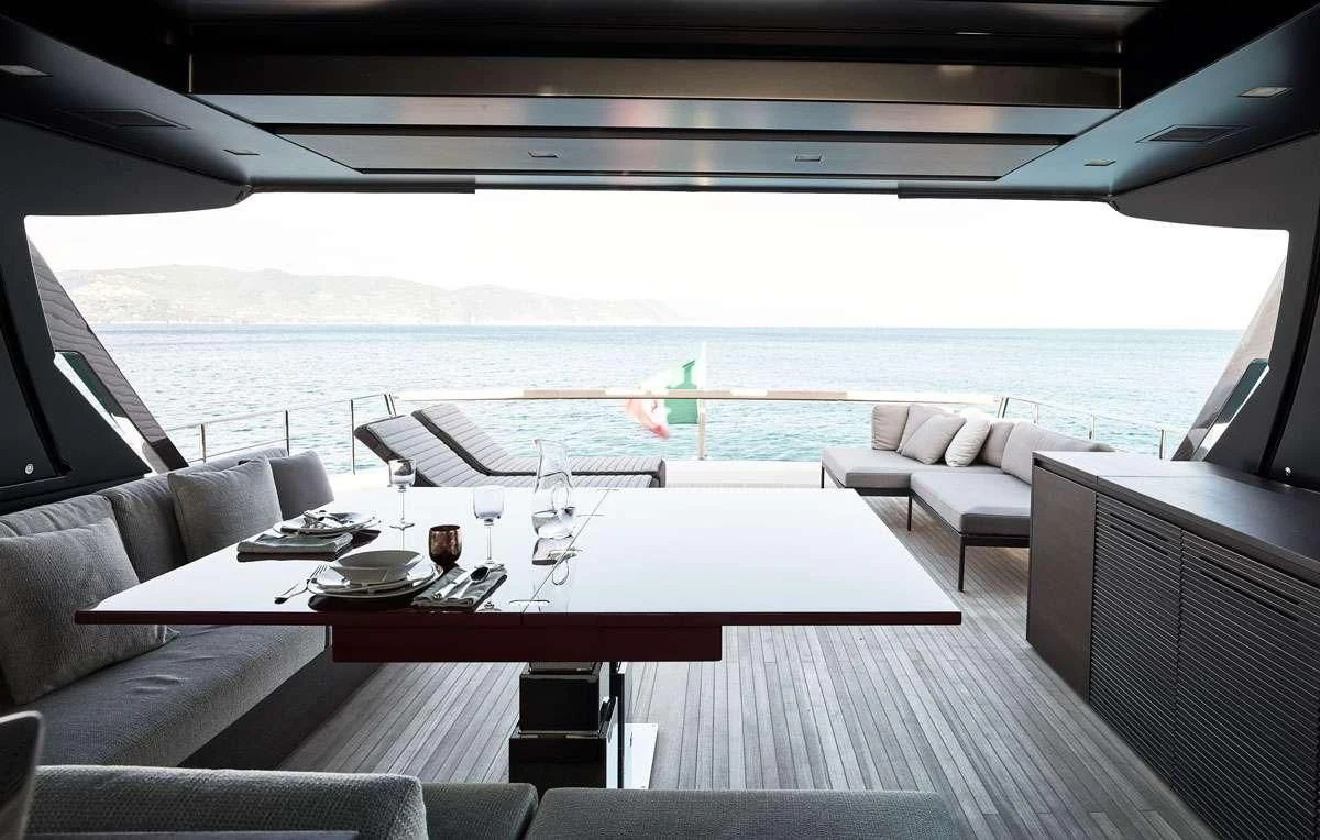 a large room with a table and chairs aboard LUAR Yacht for Charter