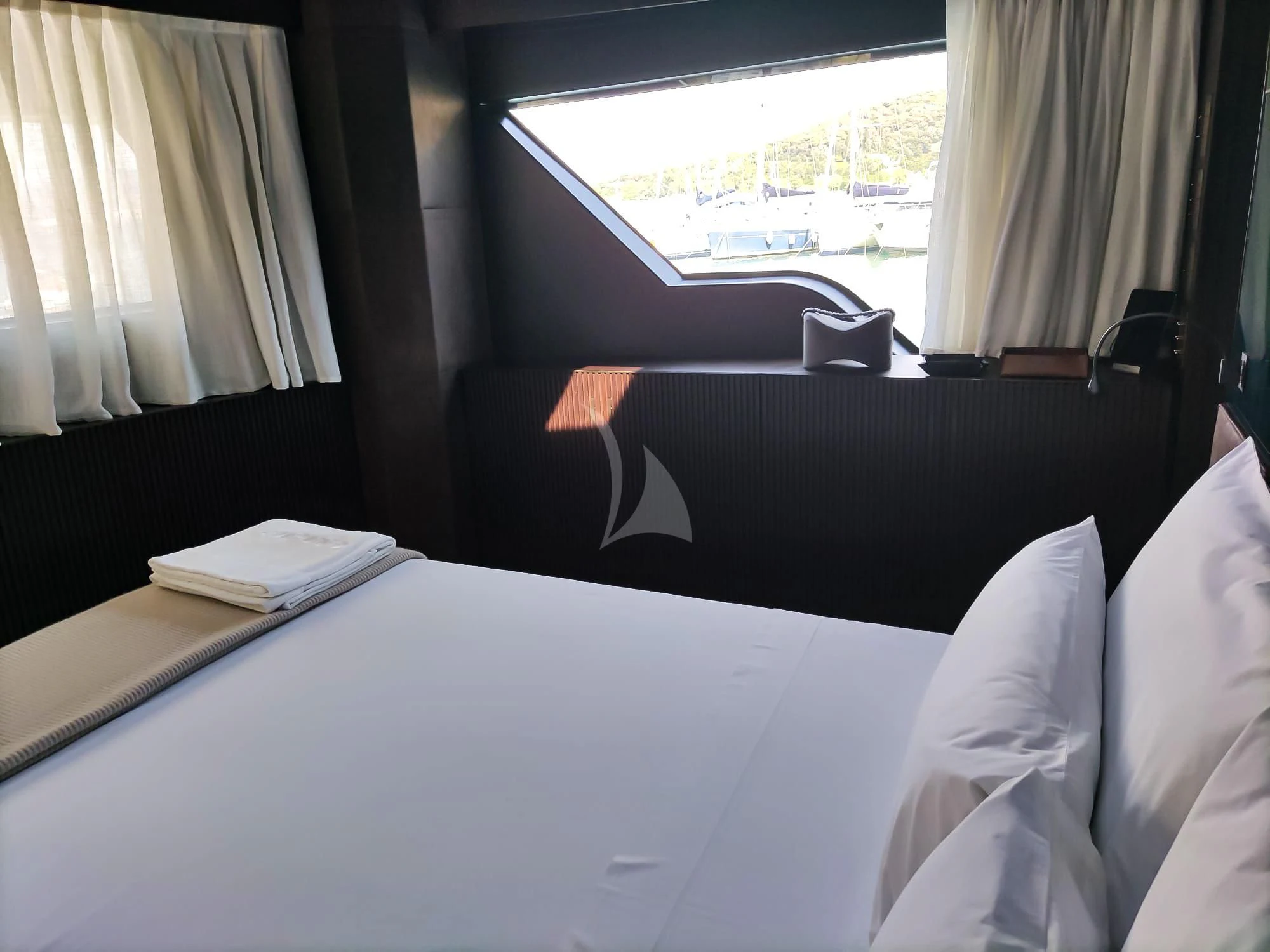 a room with a bed and a window aboard LUAR Yacht for Charter