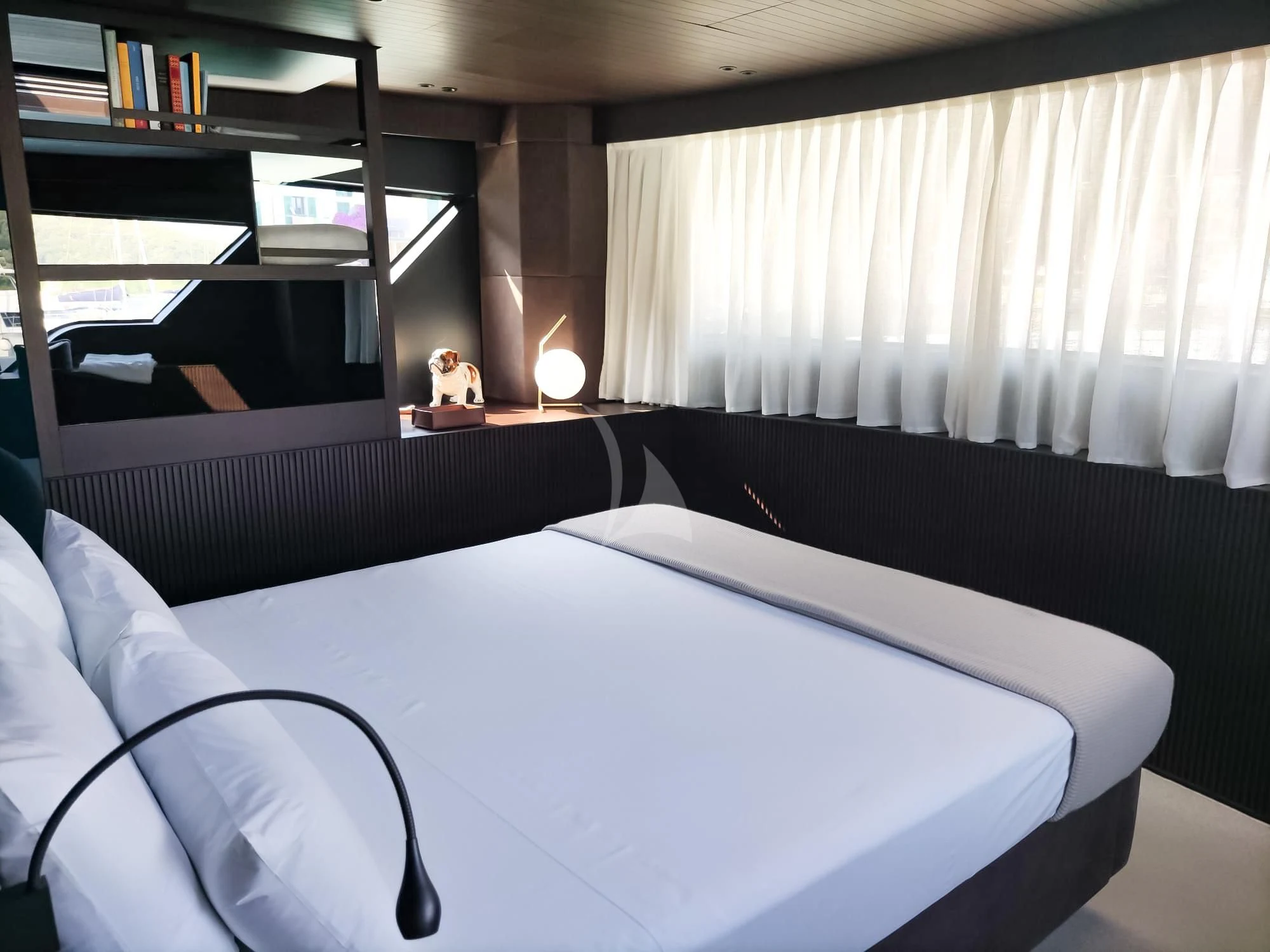 a bed with a white sheet aboard LUAR Yacht for Charter