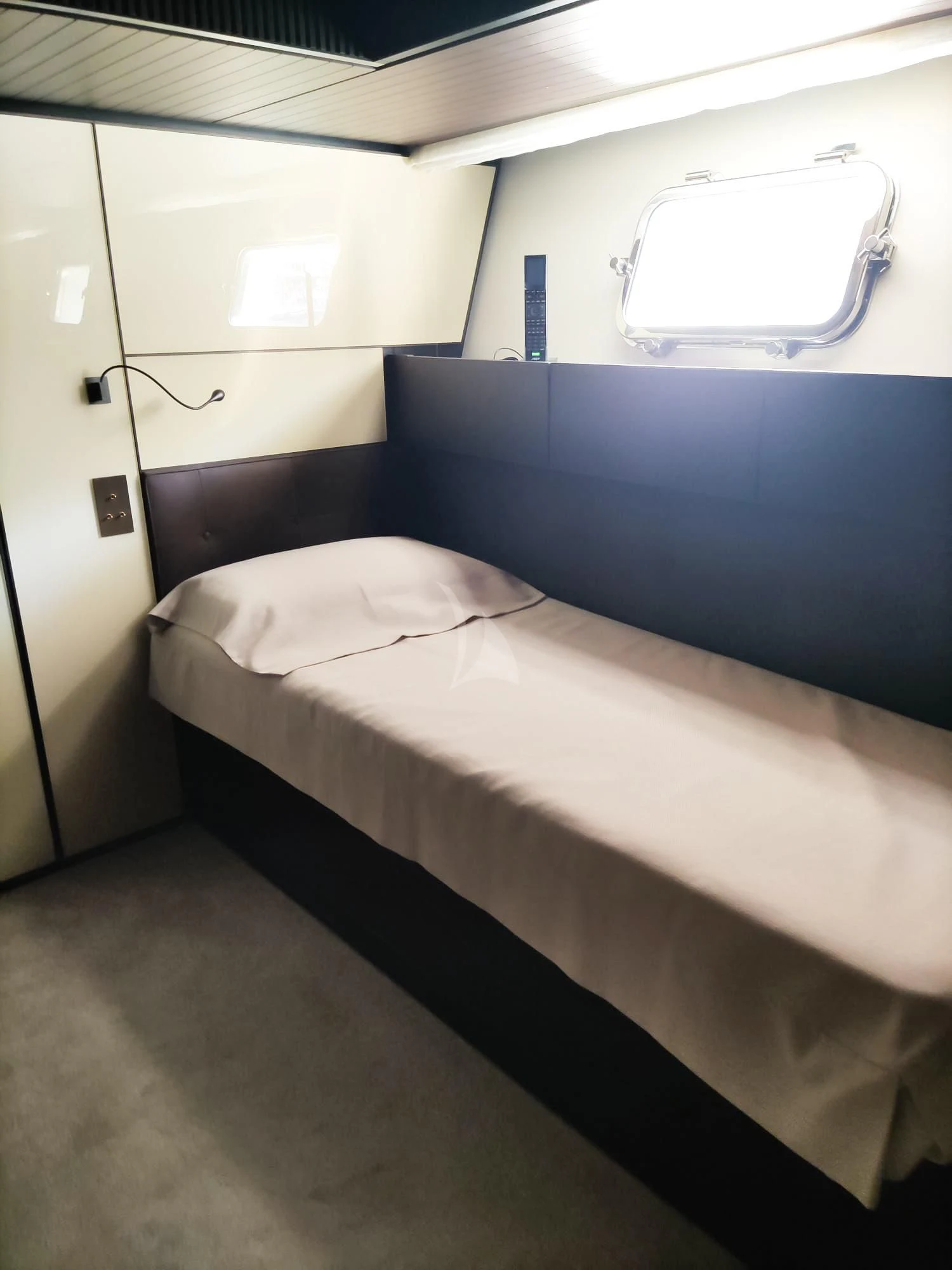 a bed with a white sheet aboard LUAR Yacht for Charter