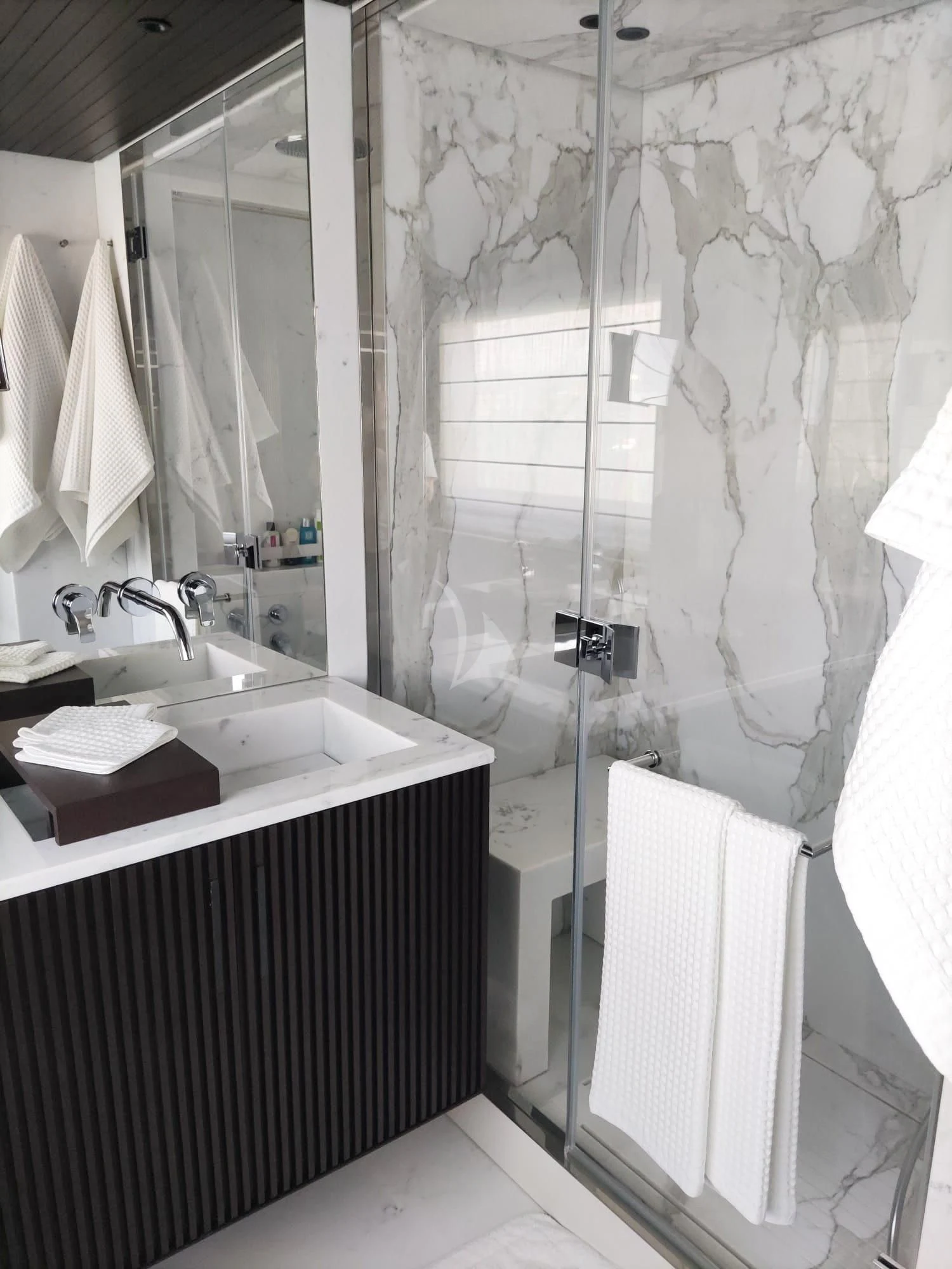 a bathroom with a shower curtain aboard LUAR Yacht for Charter