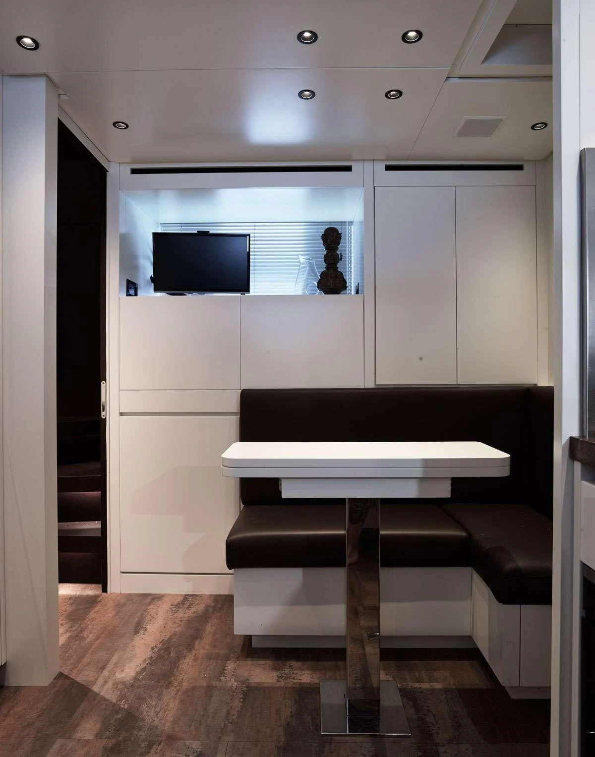 a room with a couch and a television aboard LUAR Yacht for Charter