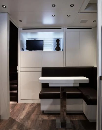 a room with a table and chairs aboard LUAR Yacht for Charter