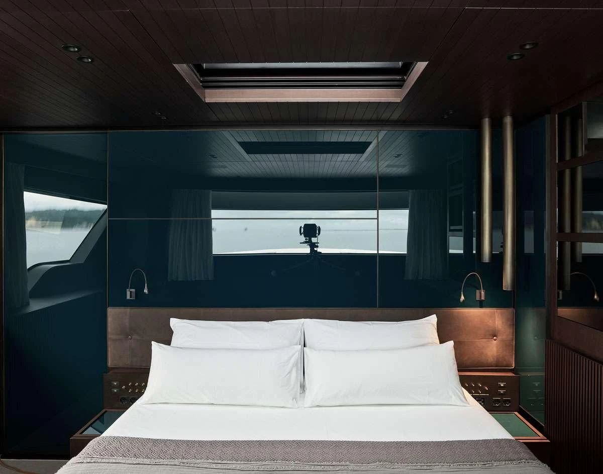 a bed with white sheets aboard LUAR Yacht for Charter