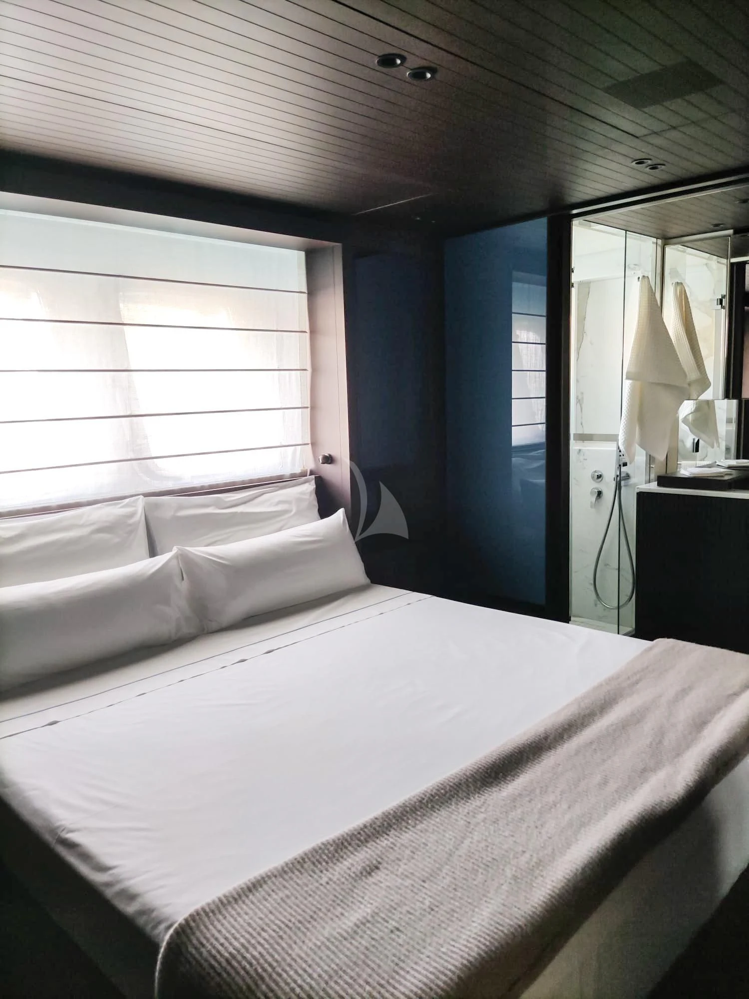 a bed with a white sheet aboard LUAR Yacht for Charter