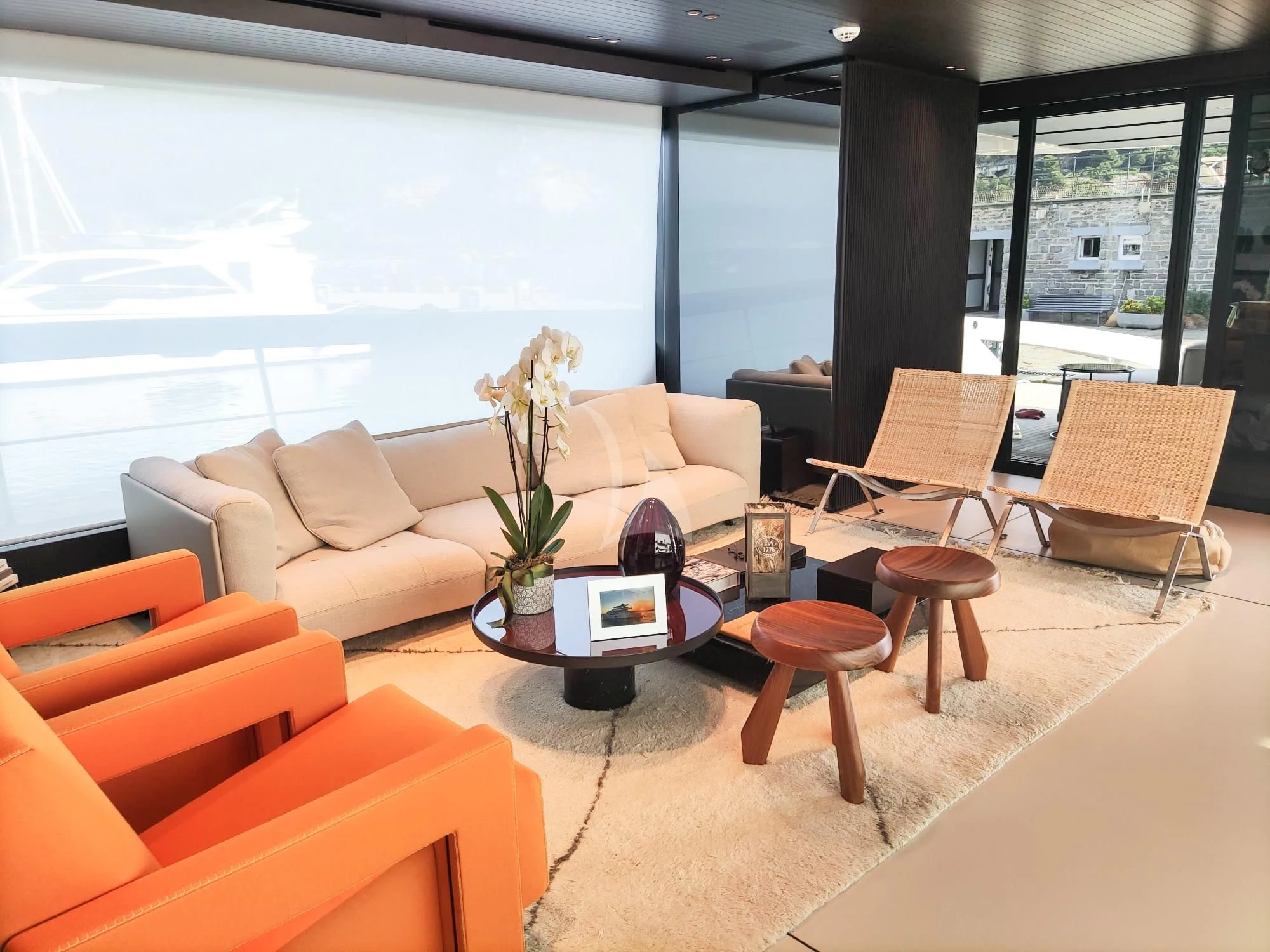 a living room with a large window aboard LUAR Yacht for Charter