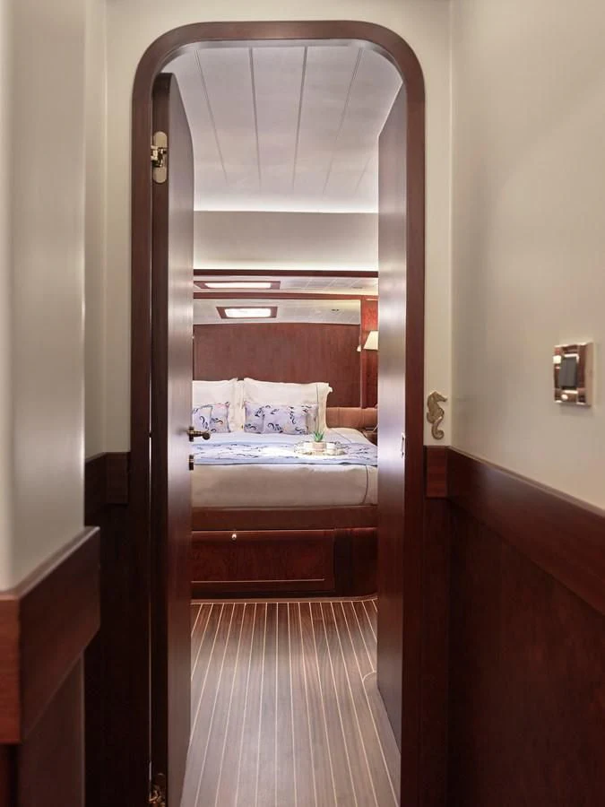a bedroom with a bed and a mirror aboard KAFTAN Yacht for Sale