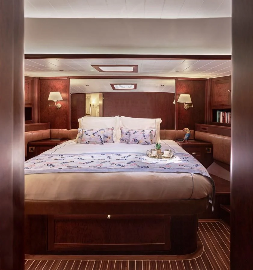 a bed with a flowered bed aboard KAFTAN Yacht for Sale