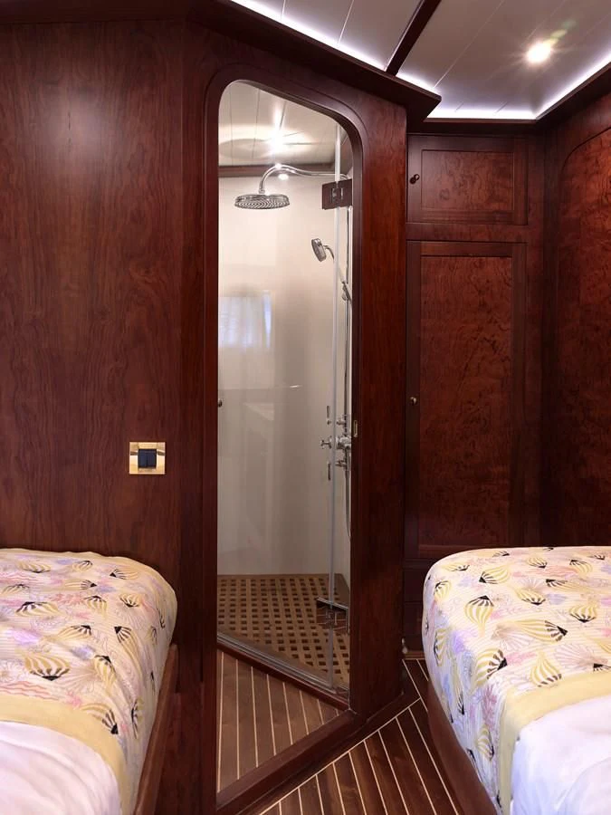a room with a bed and a mirror aboard KAFTAN Yacht for Sale
