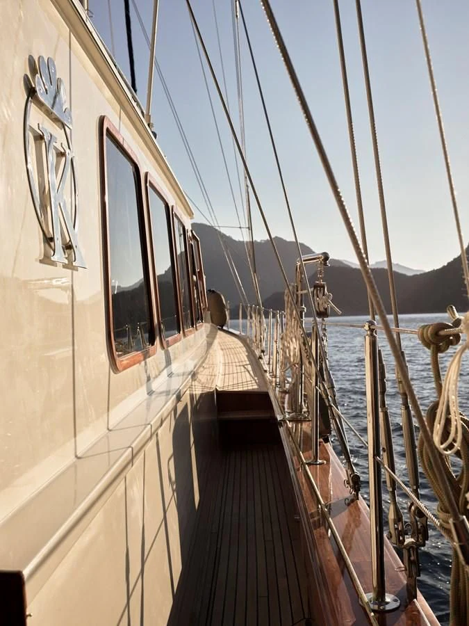 a boat is parked on the side of the water aboard KAFTAN Yacht for Sale